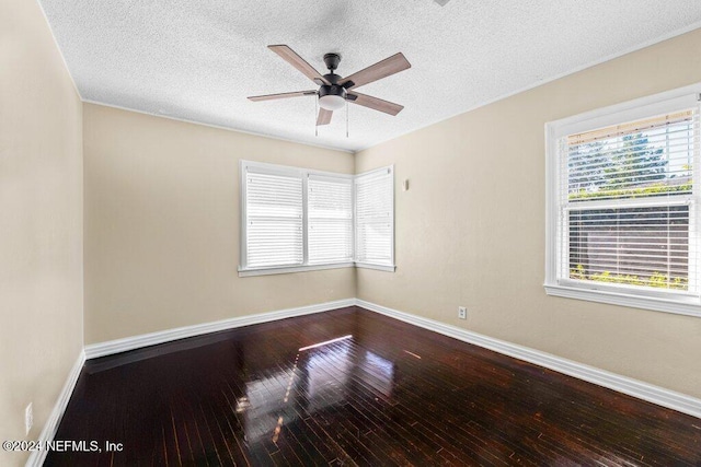 empty room with a textured ceiling, hardwood / wood-style flooring, and ceiling fan