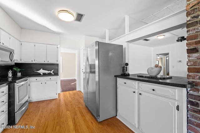 kitchen with backsplash, light hardwood / wood-style flooring, white cabinets, and stainless steel appliances