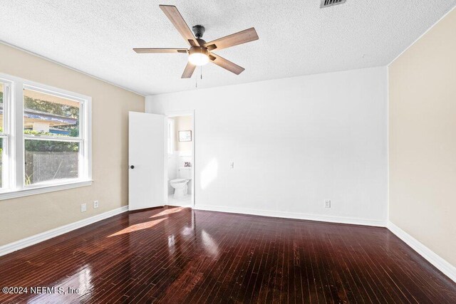 spare room featuring ceiling fan, wood-type flooring, and a textured ceiling