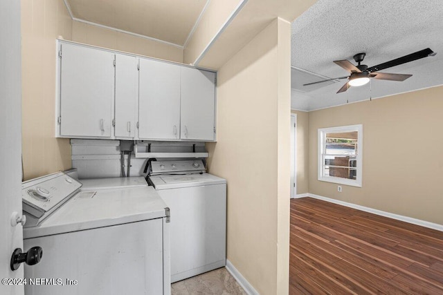 laundry room with cabinets, a textured ceiling, ceiling fan, hardwood / wood-style flooring, and washing machine and clothes dryer