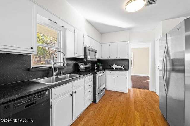 kitchen with decorative backsplash, stainless steel appliances, light hardwood / wood-style floors, and sink