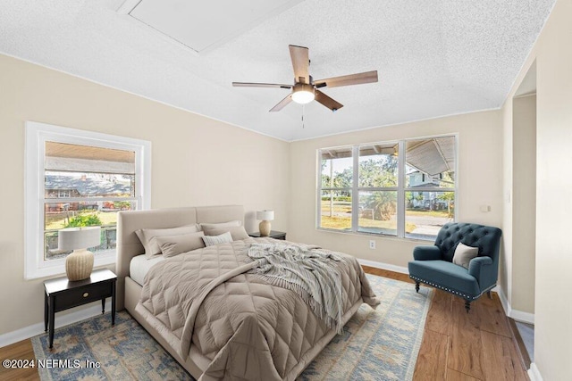 bedroom featuring wood-type flooring, a textured ceiling, and ceiling fan