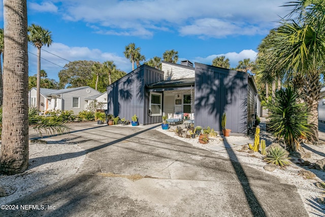 rear view of property with covered porch