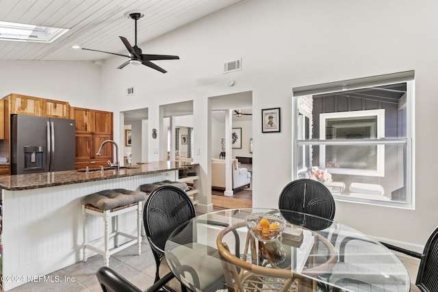 dining room with high vaulted ceiling, sink, ceiling fan, light tile patterned flooring, and wood ceiling