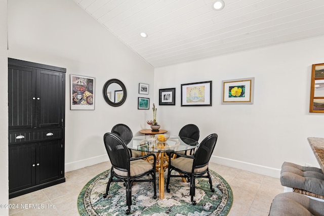 dining room with light tile patterned flooring and lofted ceiling