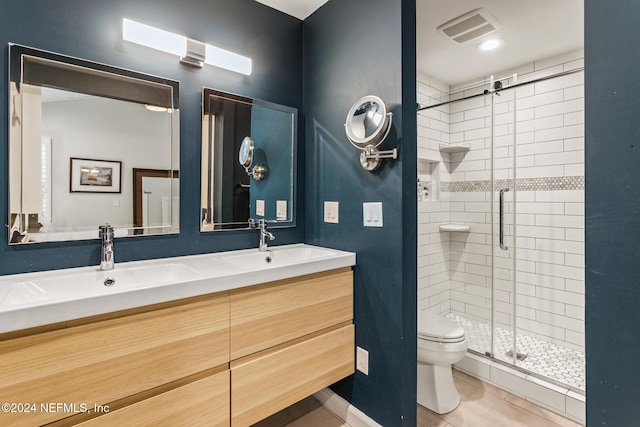 bathroom with toilet, tile patterned flooring, vanity, and walk in shower