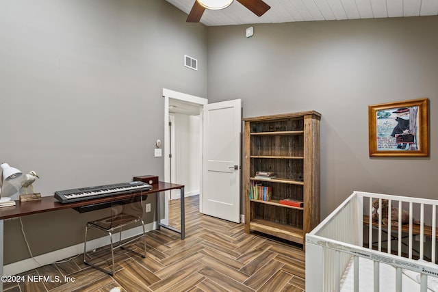 bedroom featuring ceiling fan, parquet floors, and high vaulted ceiling