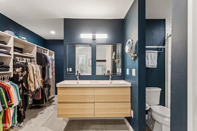 bathroom with tile patterned flooring, vanity, and toilet