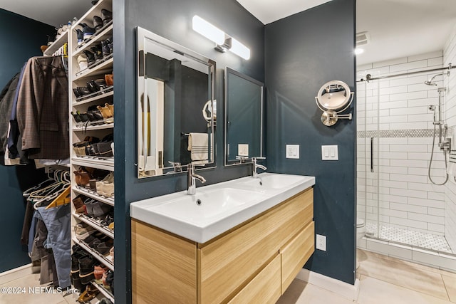 bathroom with tile patterned flooring, vanity, toilet, and an enclosed shower