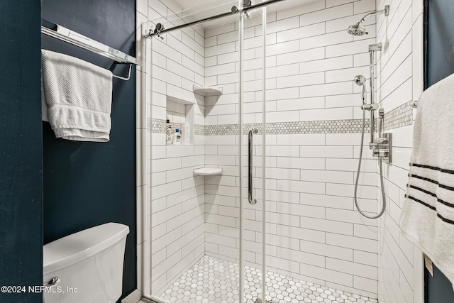 bathroom featuring an enclosed shower and toilet