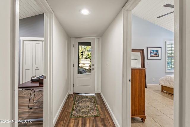 hallway featuring light hardwood / wood-style flooring and lofted ceiling