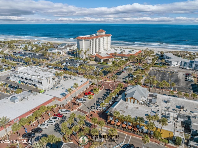 bird's eye view with a water view and a beach view