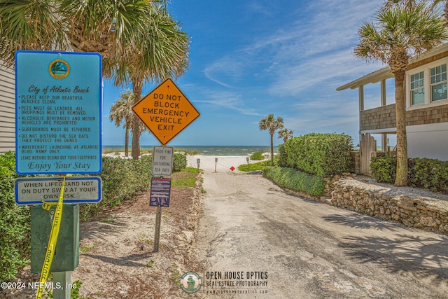 view of street with a beach view and a water view