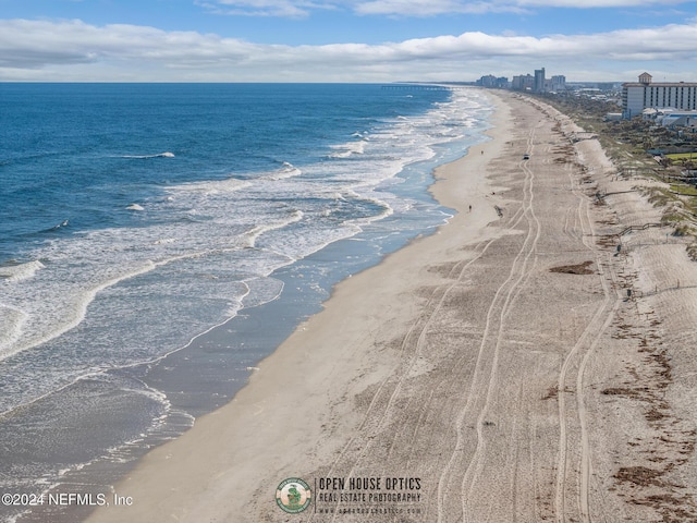 bird's eye view with a water view and a beach view