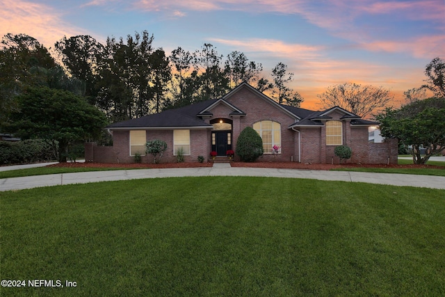 single story home featuring a yard