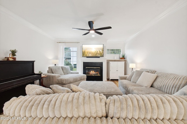 living room featuring ceiling fan, hardwood / wood-style flooring, and ornamental molding