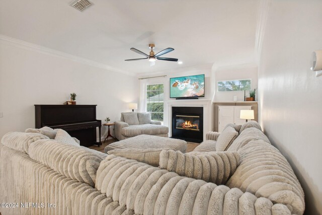 living room with crown molding, hardwood / wood-style floors, and ceiling fan