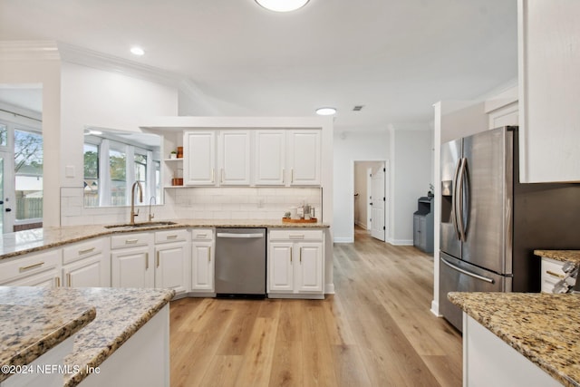 kitchen with white cabinets, light wood-type flooring, sink, and stainless steel appliances