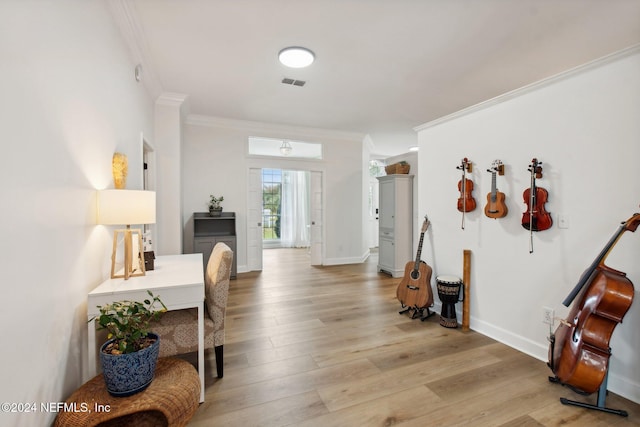 interior space featuring light hardwood / wood-style flooring and ornamental molding