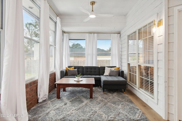 sunroom / solarium featuring ceiling fan