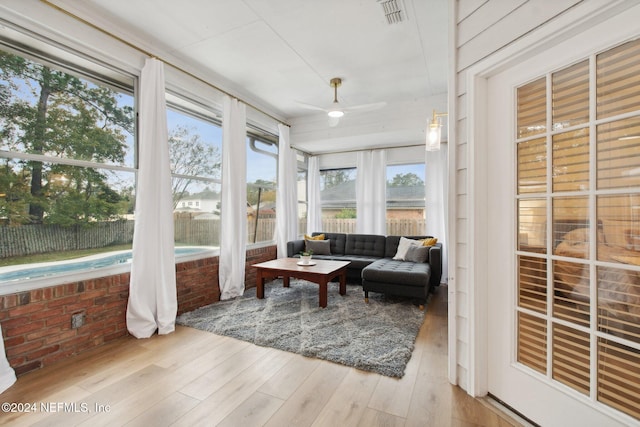 sunroom / solarium featuring ceiling fan