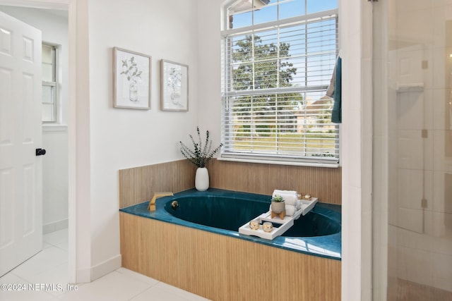 bathroom featuring plus walk in shower and tile patterned floors