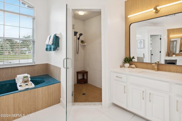 bathroom featuring shower with separate bathtub, vanity, tile patterned floors, and a healthy amount of sunlight