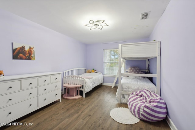 bedroom with dark hardwood / wood-style flooring