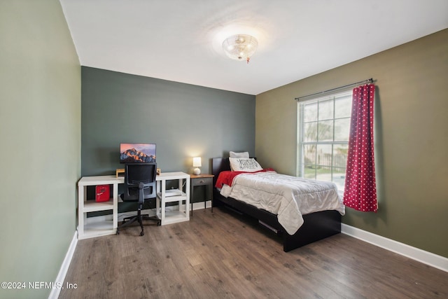 bedroom with hardwood / wood-style flooring