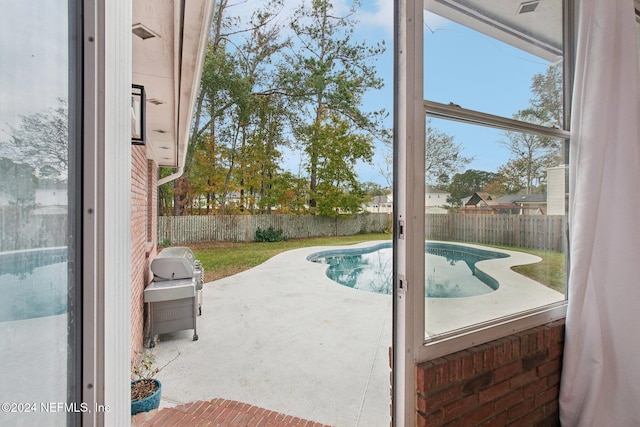 view of pool with a grill and a patio