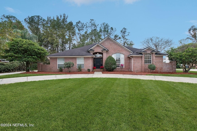 ranch-style house with a front lawn