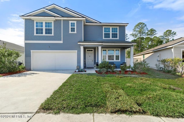 view of front of property featuring a front lawn and a garage