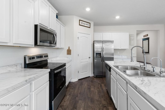 kitchen featuring sink, white cabinetry, stainless steel appliances, and dark wood-type flooring