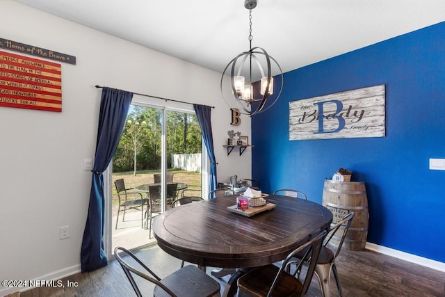 dining space featuring hardwood / wood-style floors and an inviting chandelier