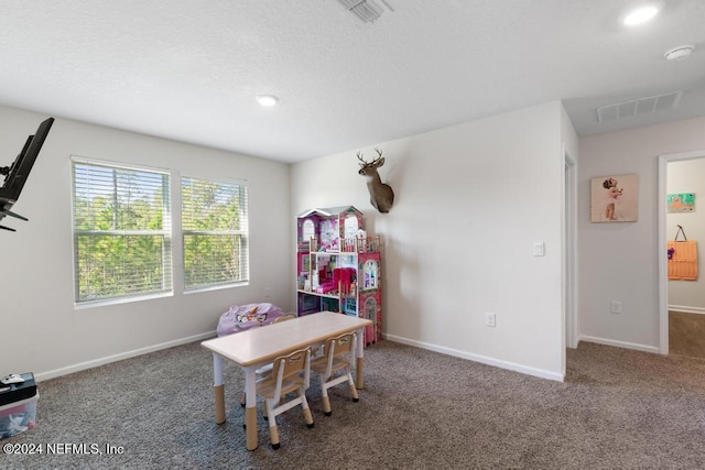 game room with dark colored carpet