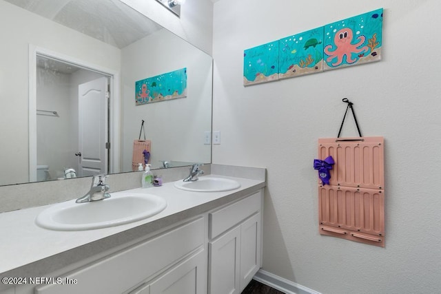 bathroom with vanity and toilet