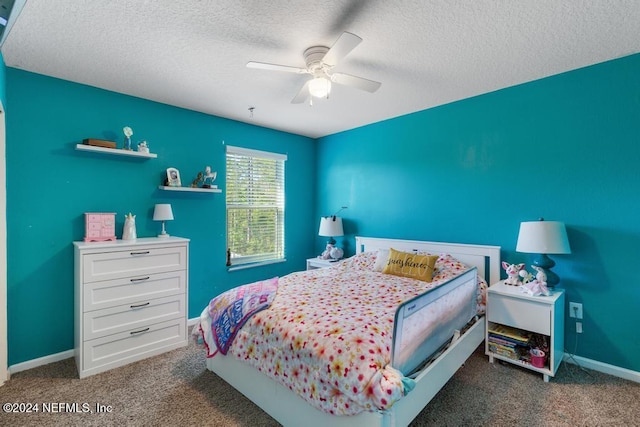 bedroom featuring dark colored carpet, ceiling fan, and a textured ceiling