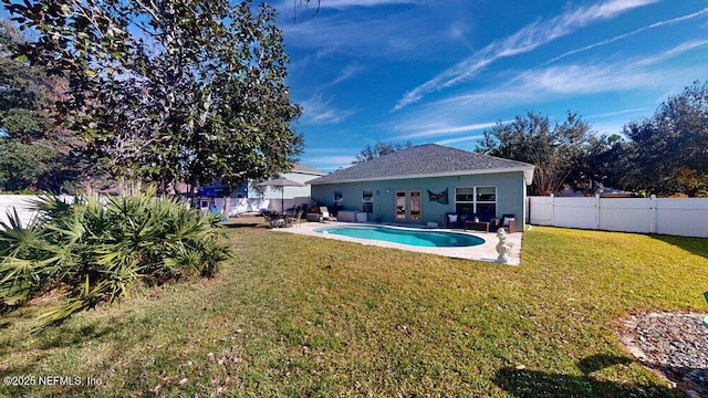 exterior space with a fenced in pool, a yard, and a patio area