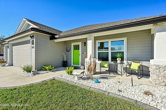 single story home featuring concrete driveway, a porch, roof with shingles, and an attached garage