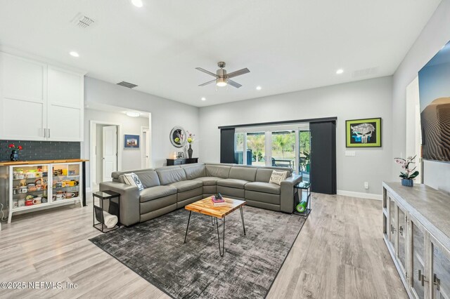 living area featuring recessed lighting, visible vents, and light wood-style flooring