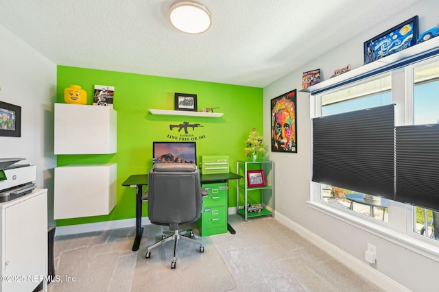 carpeted office space with baseboards and a textured ceiling