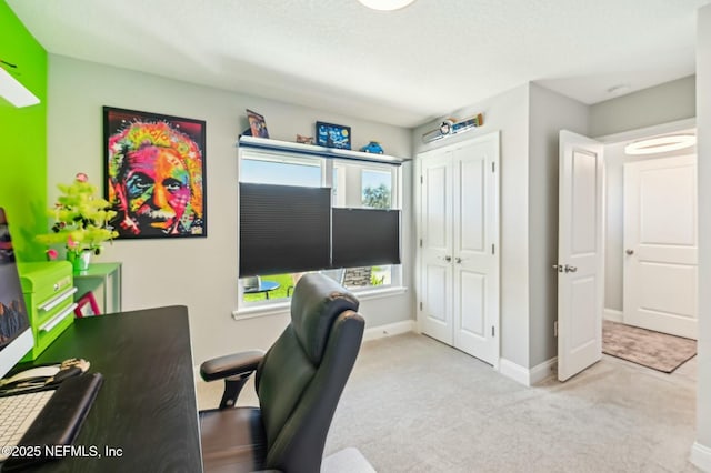 carpeted home office with baseboards