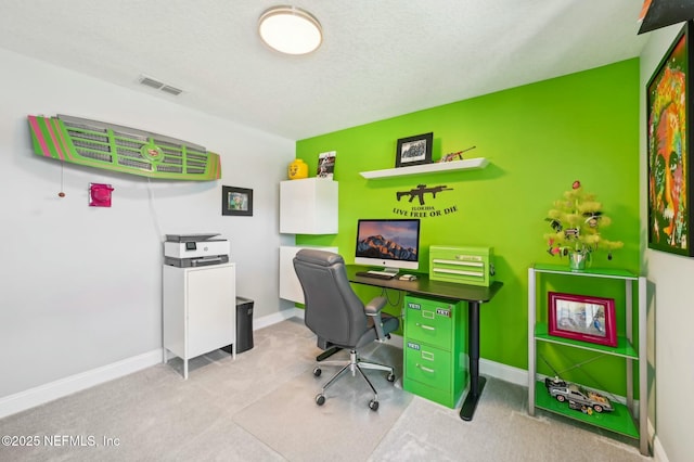 carpeted home office with visible vents, a textured ceiling, and baseboards