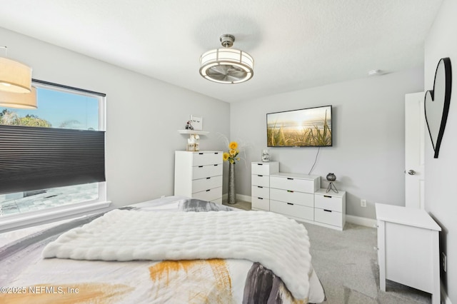 bedroom featuring carpet floors, multiple windows, and baseboards