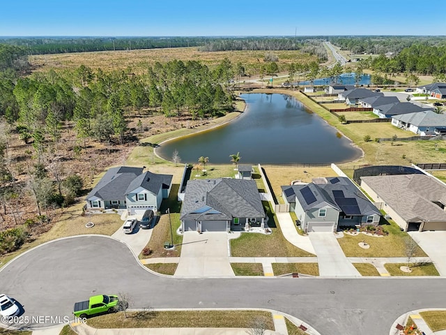 bird's eye view with a residential view, a water view, and a wooded view