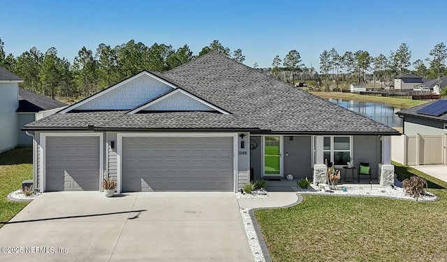 view of front of house with a garage, a shingled roof, fence, concrete driveway, and a front lawn