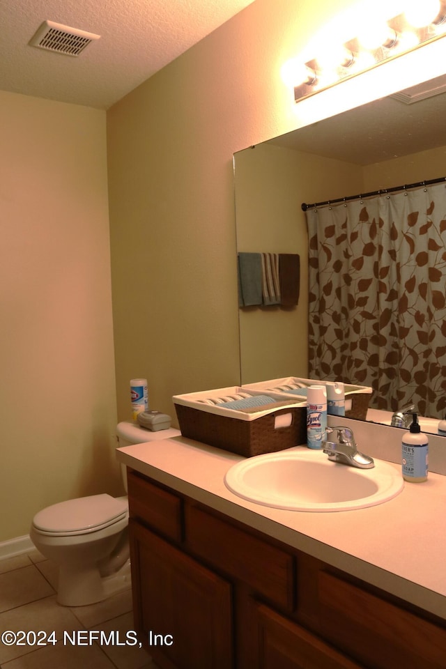 bathroom with vanity, tile patterned flooring, a shower with shower curtain, toilet, and a textured ceiling