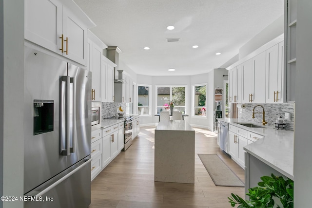 kitchen with white cabinetry, sink, and stainless steel appliances