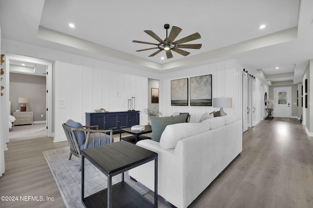 1040 Creighton Rd, Fleming Island, FL 32003 - living room featuring a raised ceiling, ceiling fan, light wood-type flooring, recessed lighting, and a decorative wall
