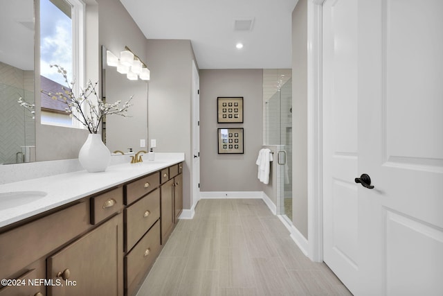 bathroom with vanity and a shower with door